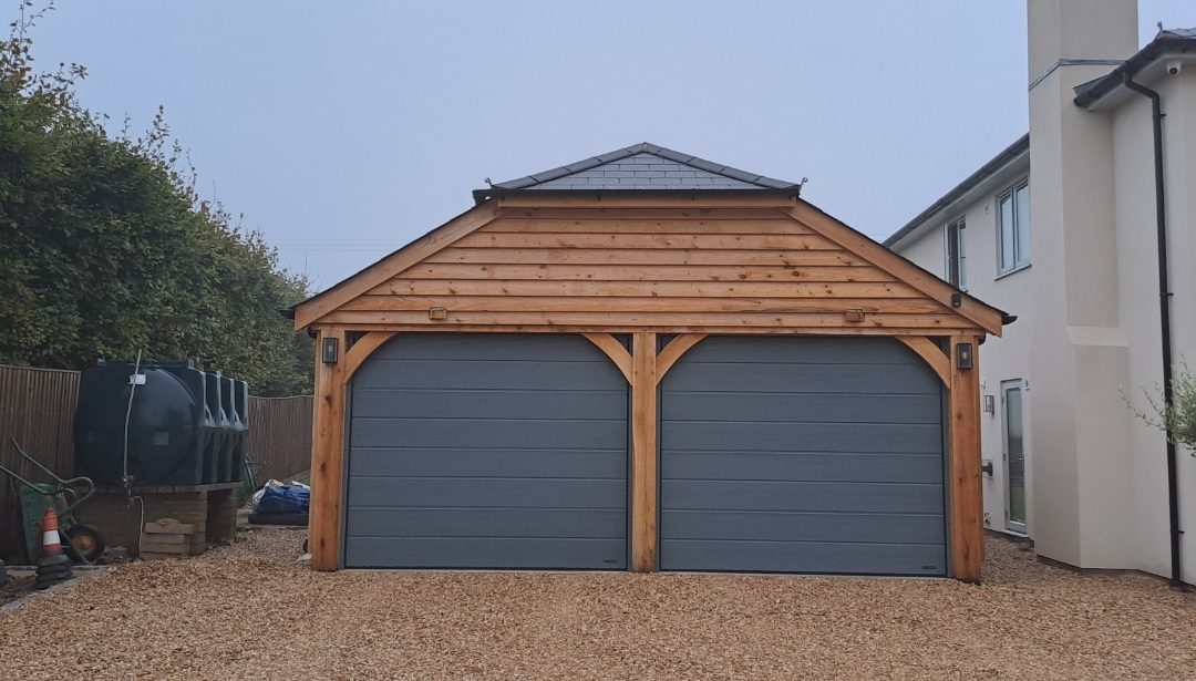 Oak Garage with half-hipped slate roof