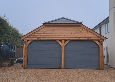 Oak Garage with half-hipped slate roof